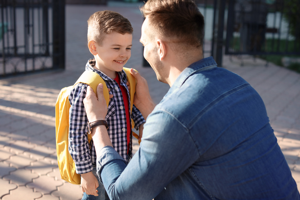 Young,Man,Saying,Goodbye,To,His,Little,Child,Near,School