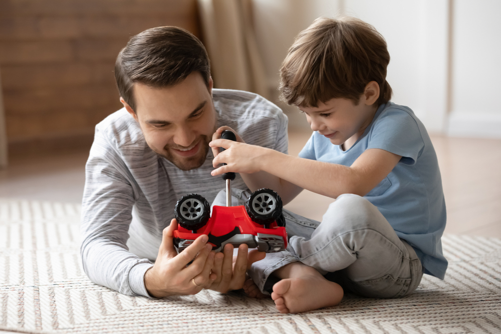 Close,Up,Son,Repairing,Toy,Car