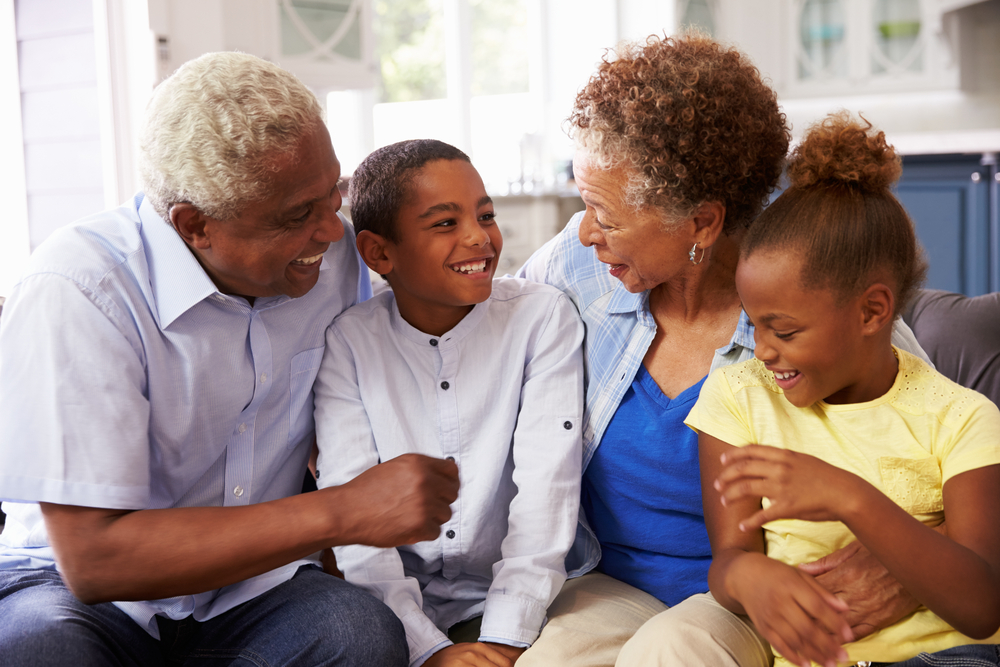 Grandparents,And,Their,Young,Grandchildren,Relaxing,At,Home