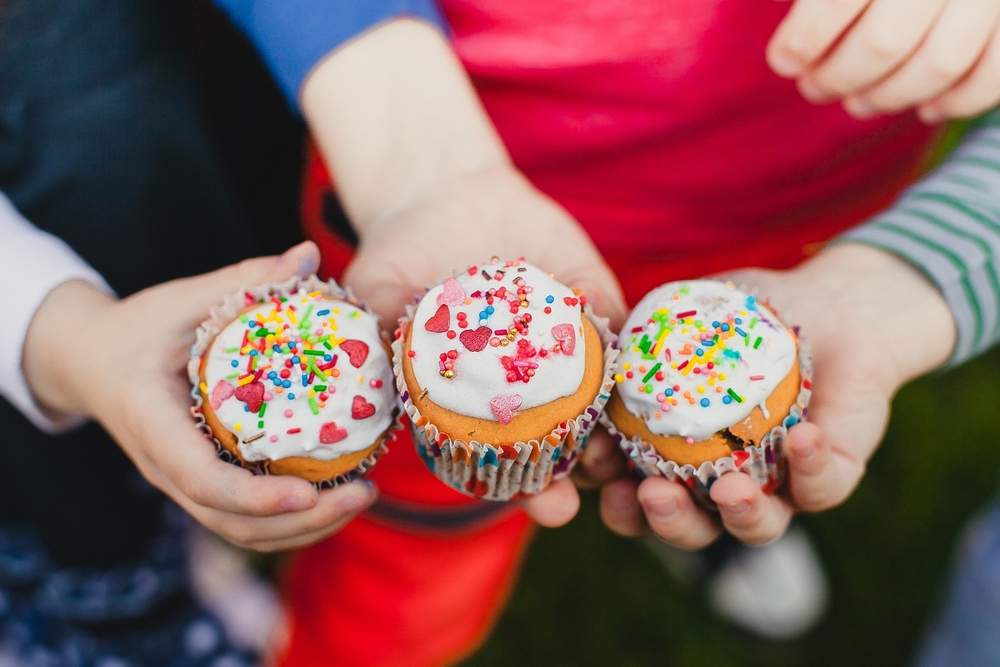 Hands,Of,Three,Children,Holding,Cakes