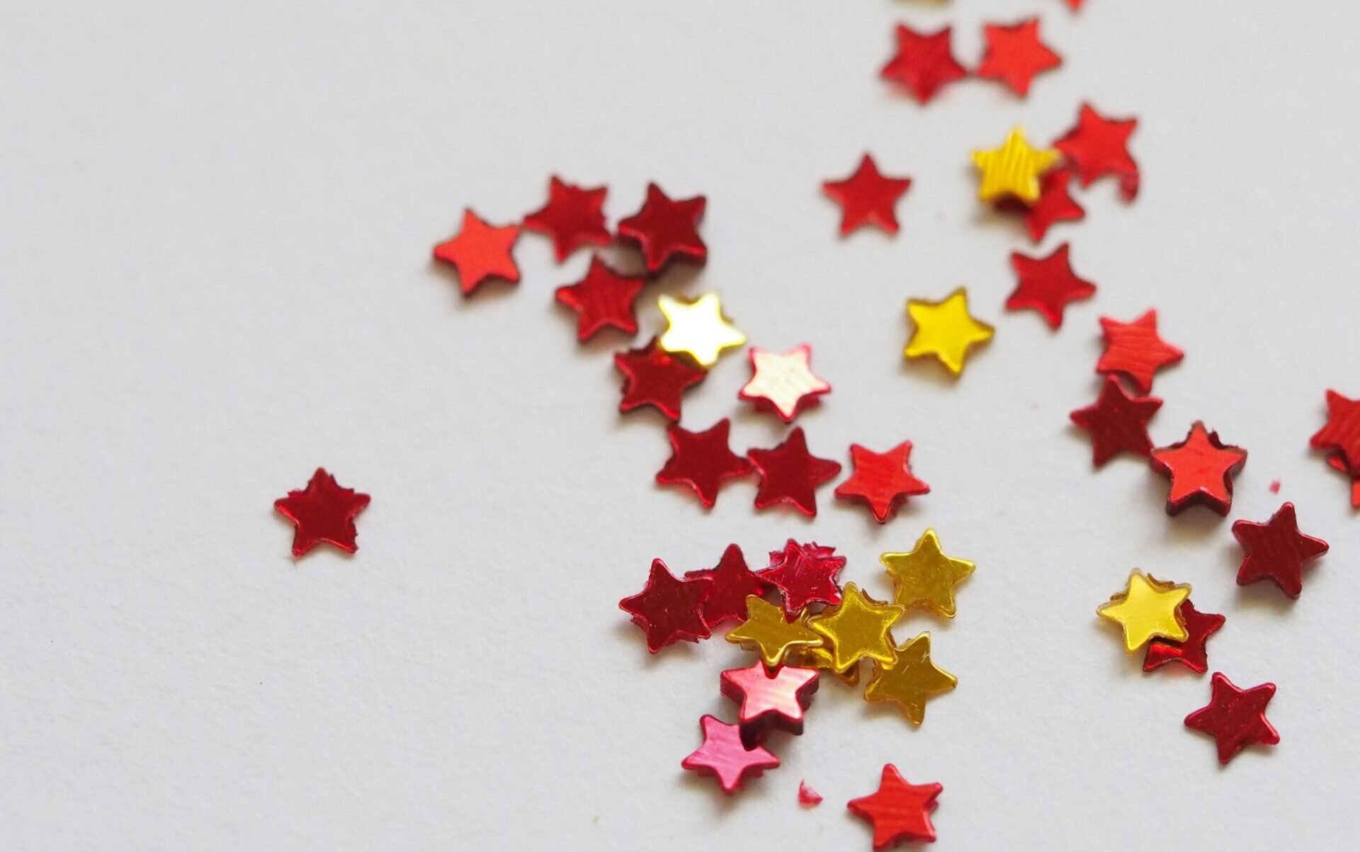 Dozens of little shiny stars scattered on a blank surface